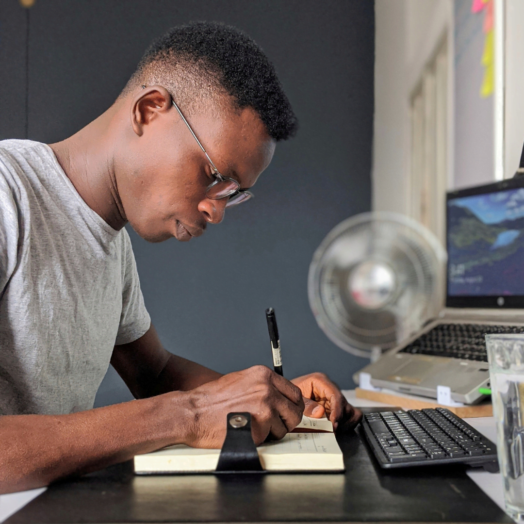 a man writing in the notebook